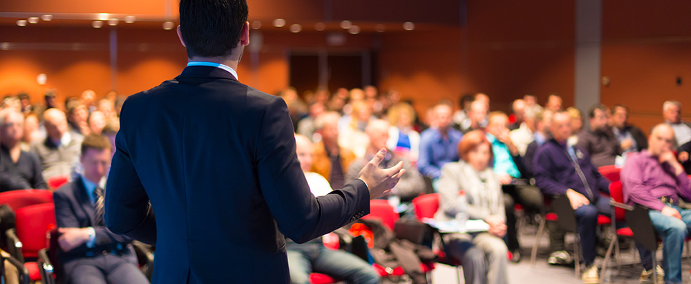 speaking at a crowded corporate event